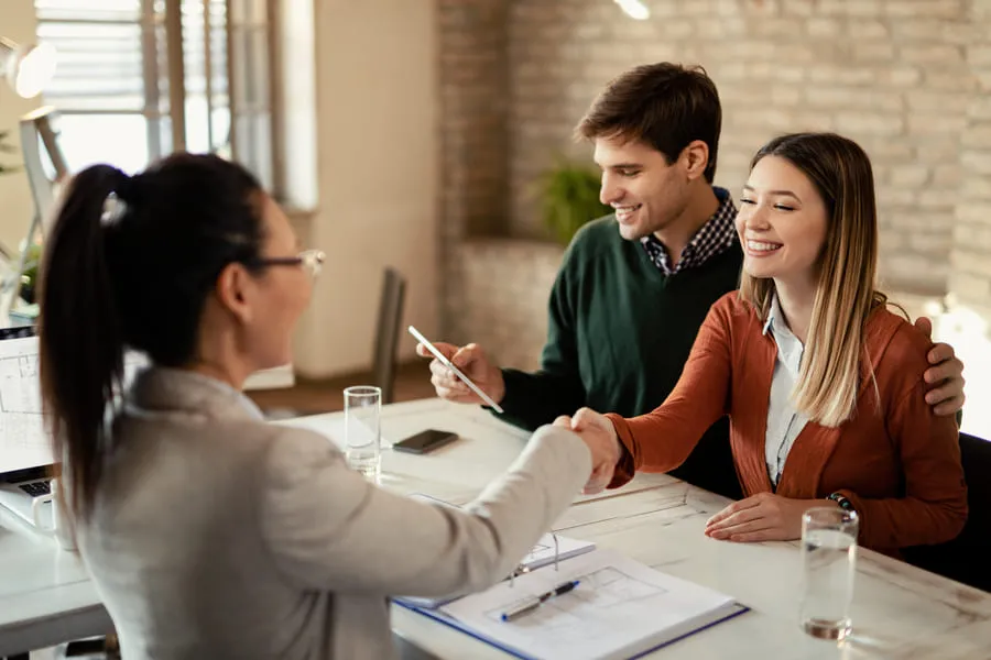 Couple meeting property manager during rental application and tenant screening interview.