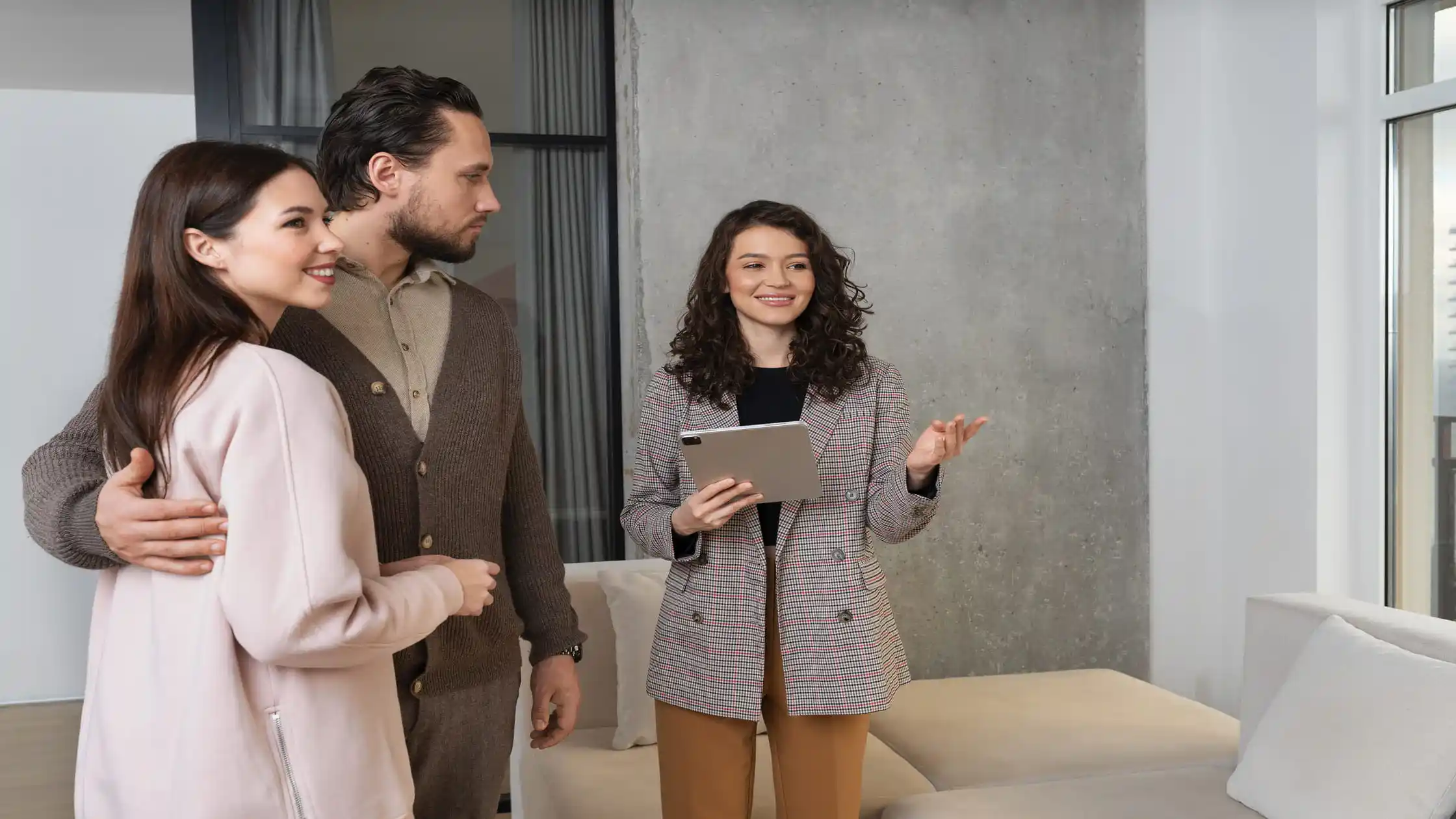 Leasing agent explaining to a couple why their apartment application was denied over credit.