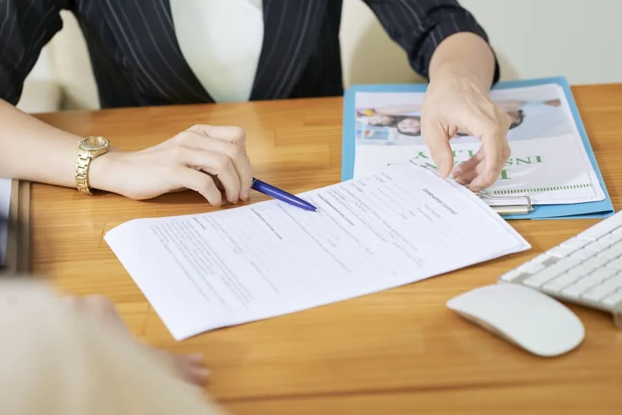 leasing-agent-marking-a-printed-rental-application-before-sending-an-adverse-action-notice-to-the-applicant