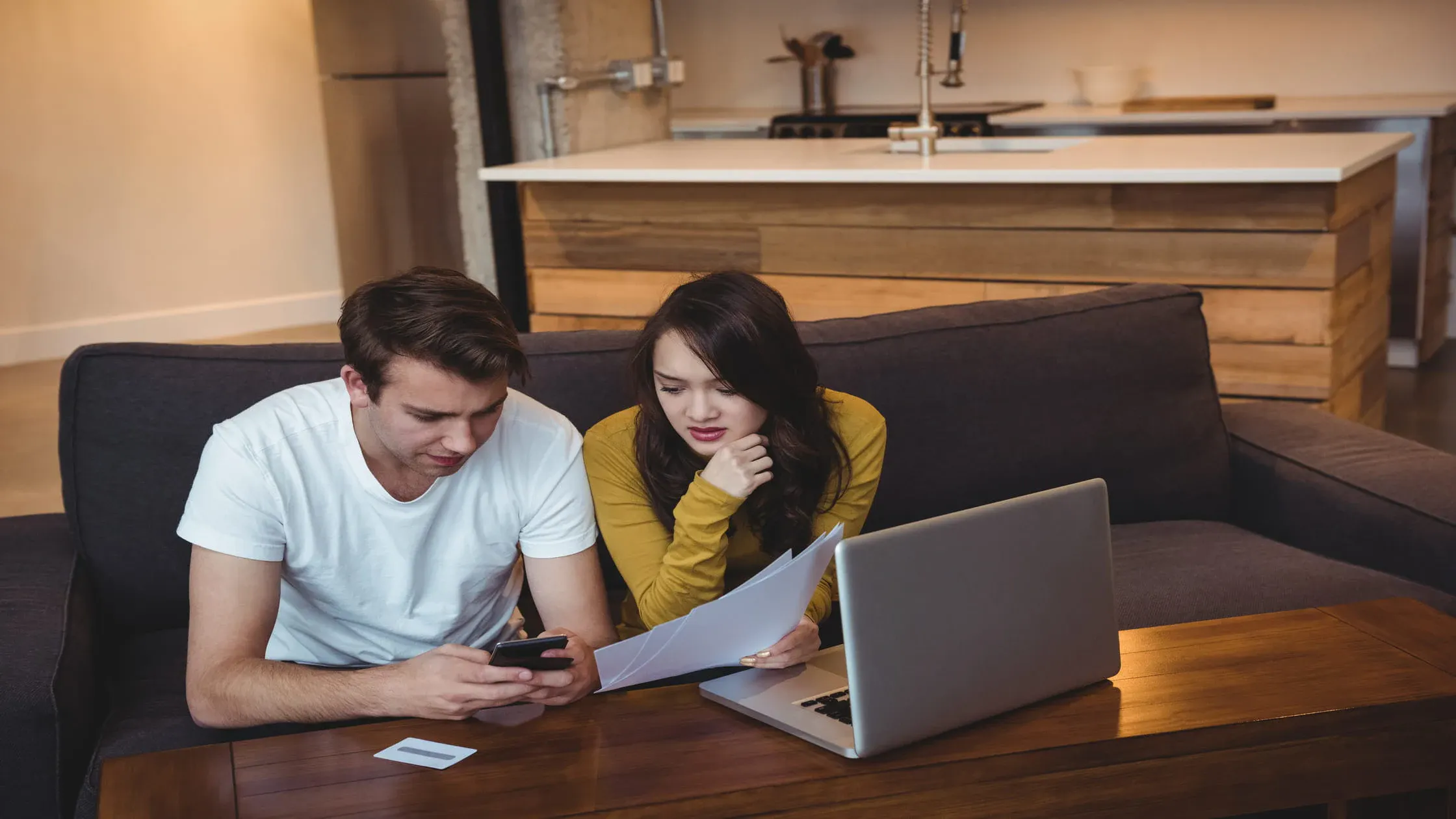 young-couple-on-couch-looking-at-laptop-how-to-find-private-landlord-online