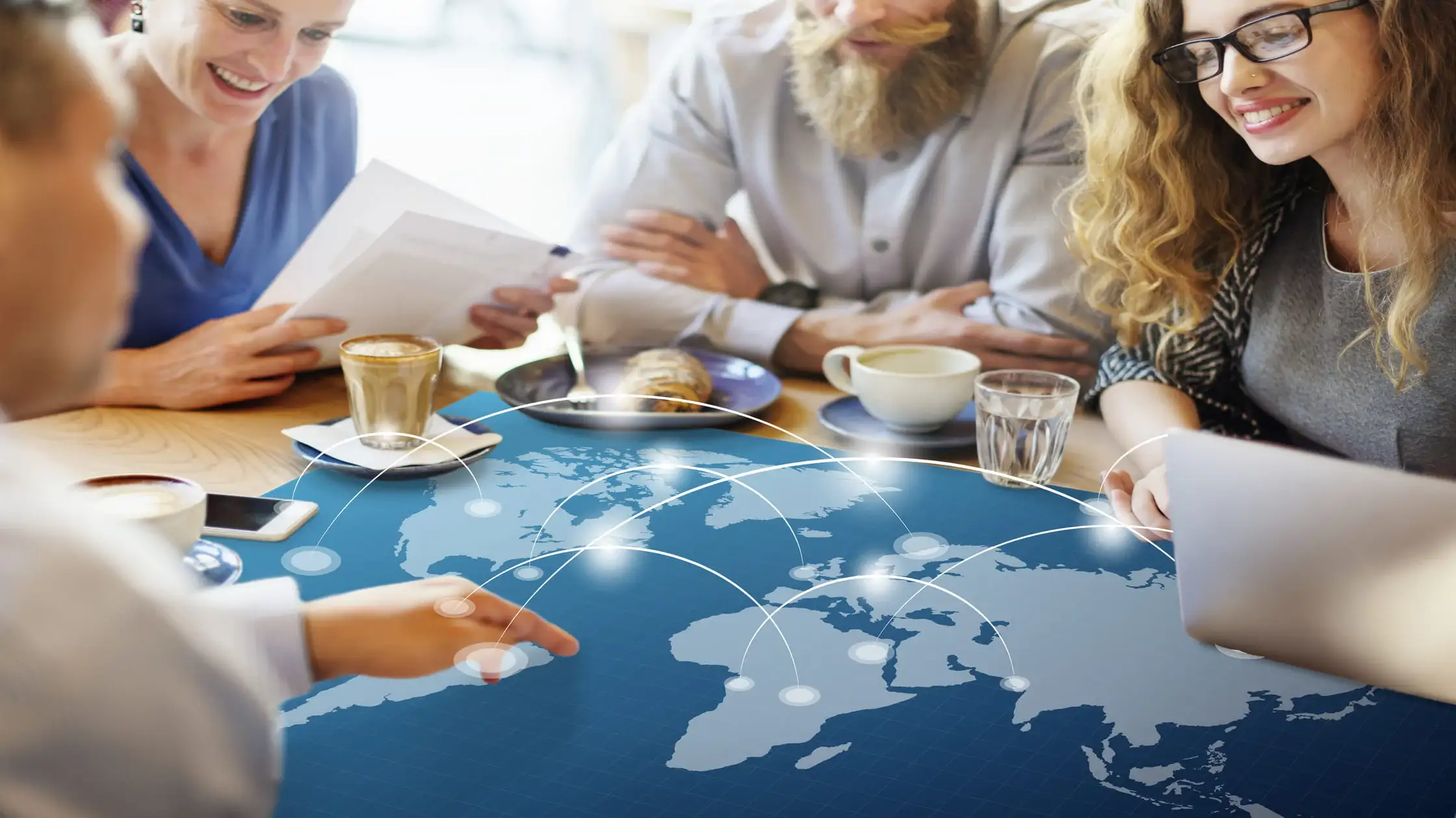 Team-reviewing-applications-over-a-world-map-showing-the-international-tenant-screening-steps