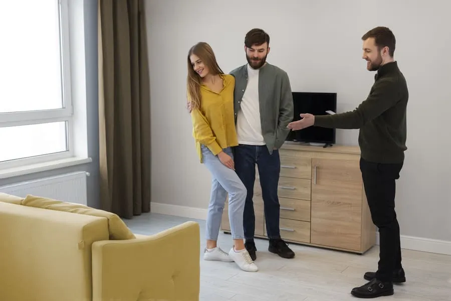 Leasing agent showing an apartment to a couple touring before renting for the first time.