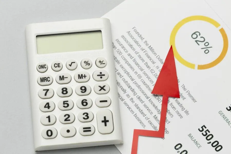Calculator beside a report showing a rising balance percentage, reflecting bank data behind an RS3 score.
