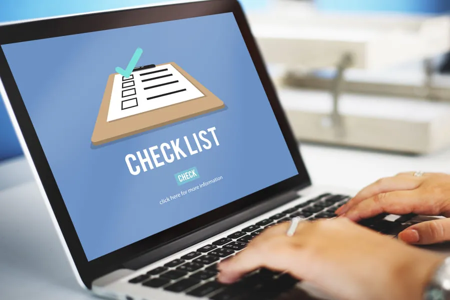 Laptop screen showing a checklist icon while tracking a rental turnover checklist online